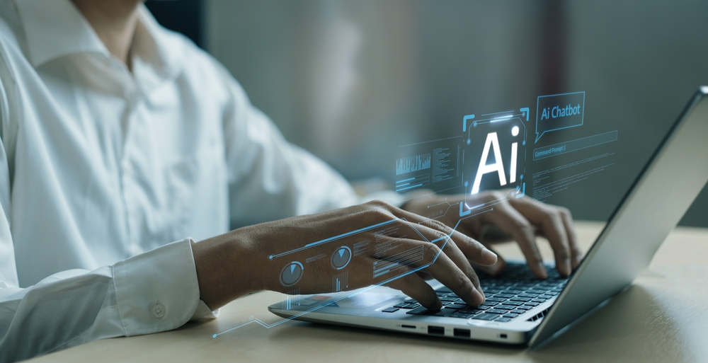 Hands typing on laptop with AI holograms.