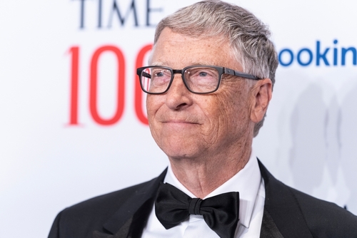 Man in suit and bow tie at Time 100 event.