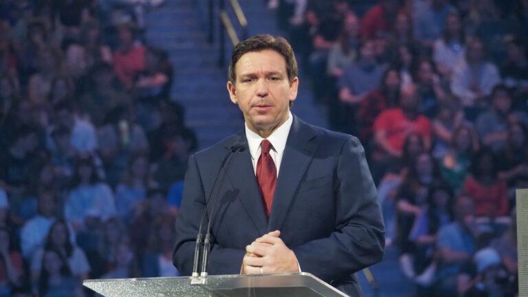 Man speaking at a podium in front of audience