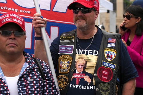 People wearing Trump gear at a political rally.