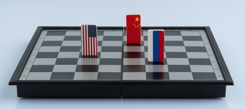 Chessboard with USA, China, and Russia flag pieces.