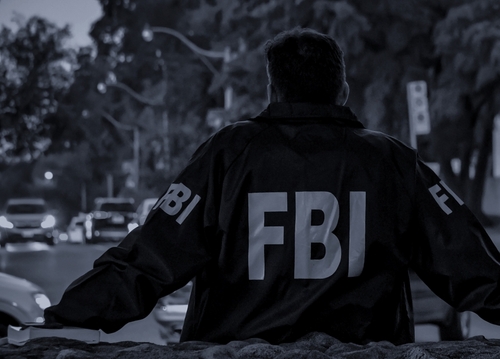 FBI agent watching traffic at night.