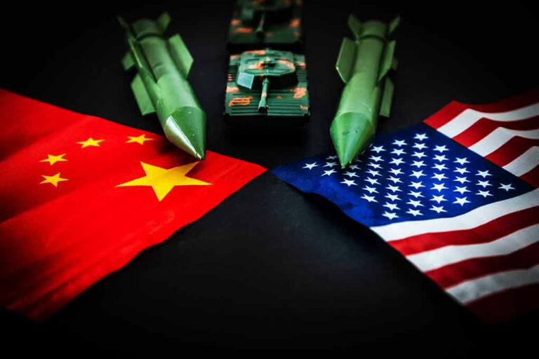 Chinese and American flags with toy missiles and tank.