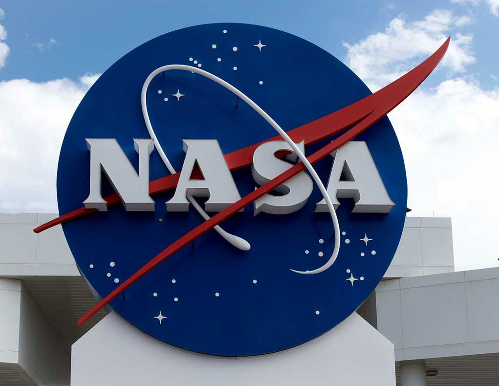 317811290 NASA logo outside building with blue sky background.