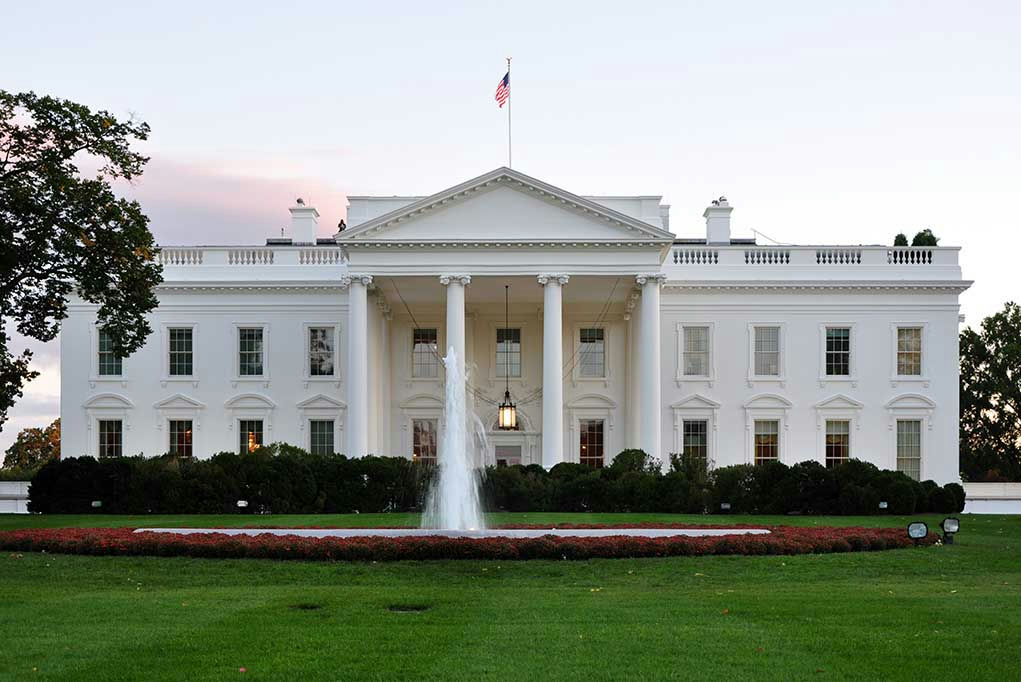 White House with fountain and flag.