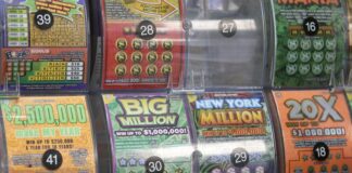 A display of various colorful lottery scratch-off tickets with different prize amounts
